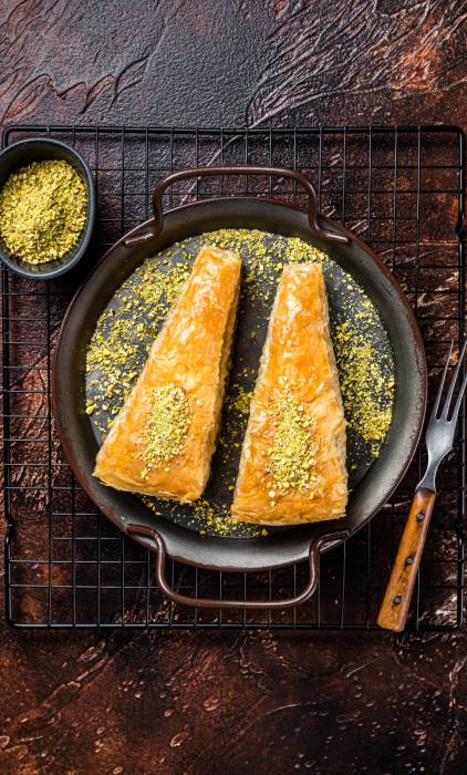 Turkish Havuc Dilim Baklava with pistachio. Dark background. Top Turkish Havuc Dilim Baklava with pistachio. Dark background. Top view.